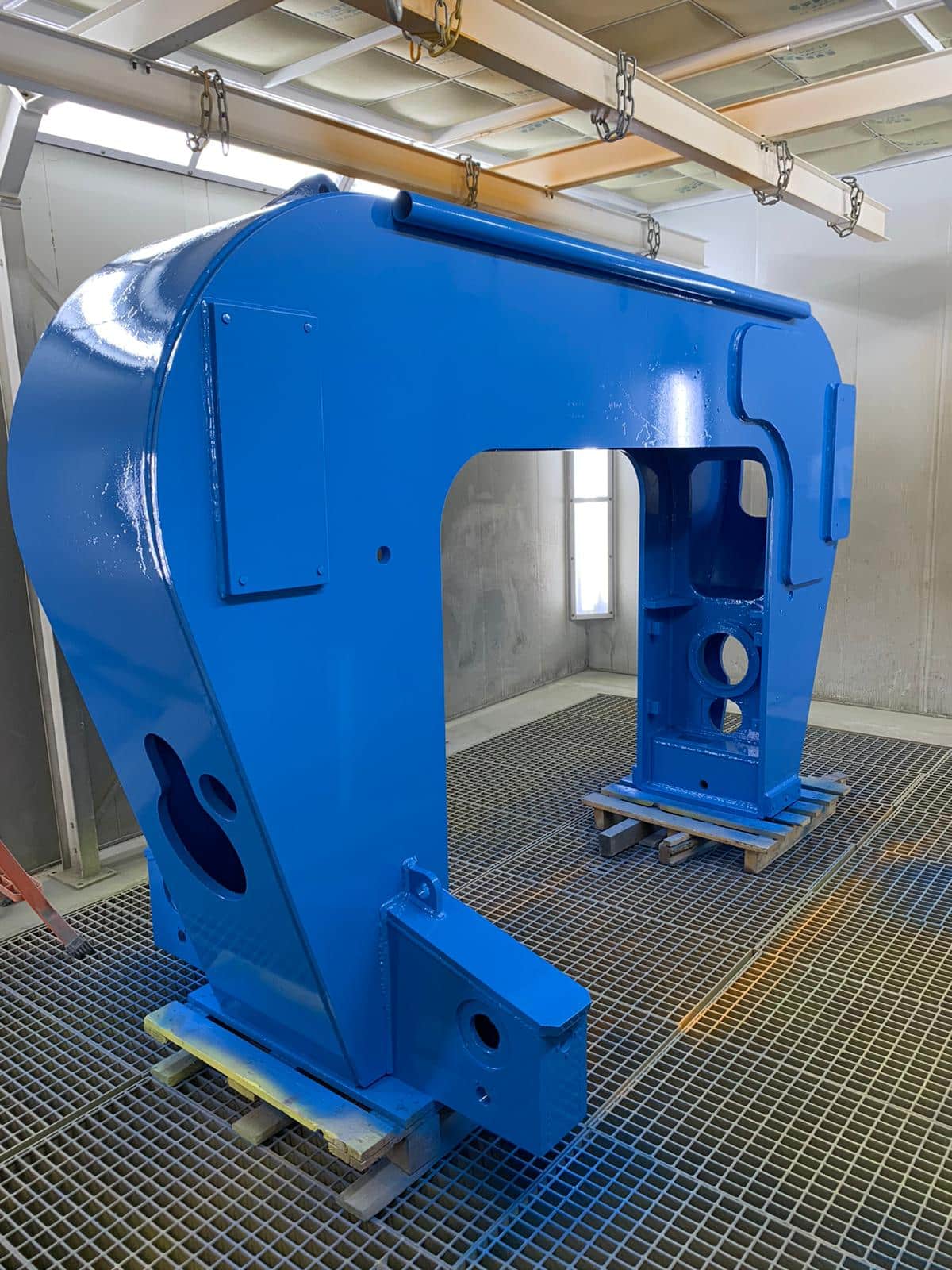 Bâti de presse peint en bleu dans la cabine de peinture liquide